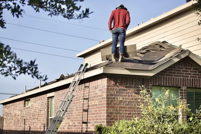 Professional roofer working on a residential roof in Farnerville